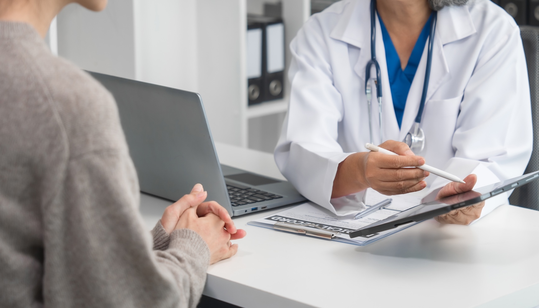 Doctor talking to a younger woman about fertility and health